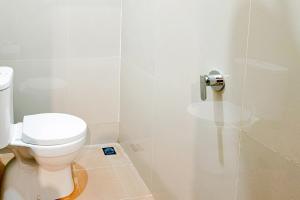 a bathroom with a toilet and a shower stall at SANS Hotel Joy Inn Brebes in Ketanggungan +27 photos
