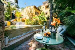 a table with a bowl of fruit on a patio at Amare Las Villas in Sayulita