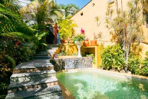 a swimming pool in the middle of a garden at Amare Las Villas in Sayulita