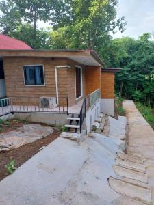 a house with stairs leading up to a house at ดงสัก สไตล์ป่า ไทรโยคน้อย in Ban Phu Pla Kang