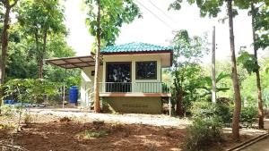 a small house in the middle of a forest at ดงสัก สไตล์ป่า ไทรโยคน้อย in Ban Phu Pla Kang +6 photos