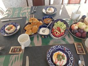 a table with plates of food on top of it at Гостевой дом AL XALIL in Samarkand +20 photos