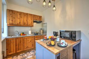 a kitchen with wooden cabinets and a counter with food on it at Starkeeper Apartment - Happy Rentals in Pragelato