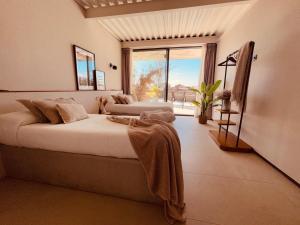 a bedroom with two beds and a large window at Villa de Diseño con Piscina Privada in Pastores