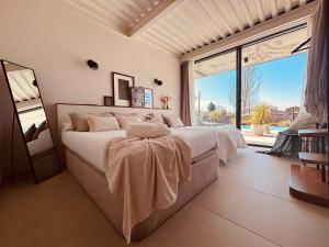 a bedroom with a large bed and a large window at Villa de Diseño con Piscina Privada in Pastores +26 photos