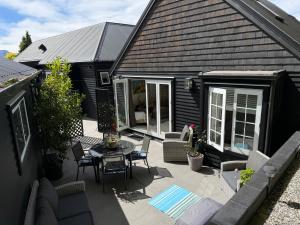 an outdoor patio with a table and chairs at Villa @23 in Wanaka