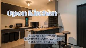 a kitchen with an open kitchen sign on the wall at Garage Base TATEYAMA in Tateyama