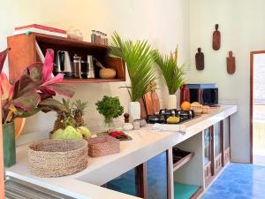 a kitchen with a counter with plants on it at Tropical Villa Canggu Beach in Dalung