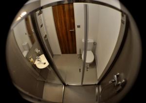 a mirror of a bathroom with a toilet and a sink at Studia Letců 2A in Olomouc