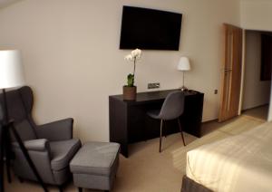 a hotel room with a desk and a chair and a bed at Studia Letců 2A in Olomouc