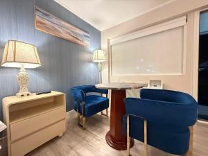 a room with a table and two blue chairs at The Aventis Inn in Somers Point