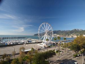 a ferris wheel in a park next to the ocean at Conte di Morelia in Salerno