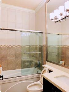 a bathroom with a tub and a toilet and a sink at Luxury Private house in Richmond +30 photos
