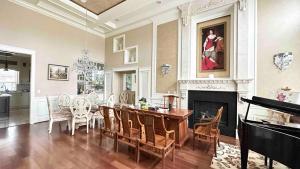 a living room with a dining table and a fireplace at Luxury Private house in Richmond