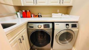 a kitchen with a washing machine and a sink at Luxury Private house in Richmond