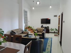 a living room with couches and a flat screen tv at Roo Heaven Villas in Haputale