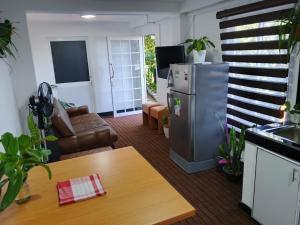 a living room with a refrigerator and a table at Roo Heaven Villas in Haputale