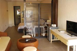a room with a desk and a room with a bed at OYO 1202 Shilla Hotel in Pampang