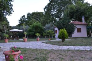 a garden with a house and a patio with flowers at Dodis Village in Platanias