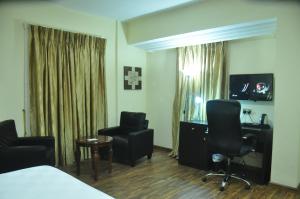 Uma televisão e/ou sistema de entretenimento em Citiheight Hotel