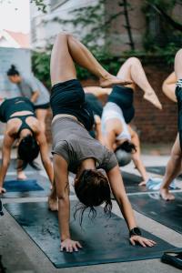 a group of women doing a yoga pose in the street at JE JA RI Stay in Seoul