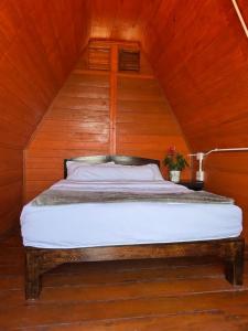 a bed in a room with a wooden ceiling at Mountain springs resort in Ban Nong Khieo +67 photos