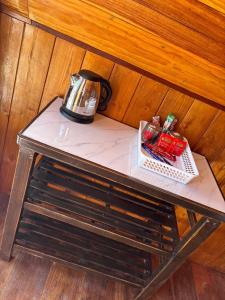 a table with a tea kettle on top of it at Mountain springs resort in Ban Nong Khieo