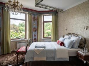 a bedroom with a large bed and a window at Kurak Homestay in Bishkek