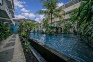 a swimming pool in the middle of a building at Abian Harmony Hotel in Sanur