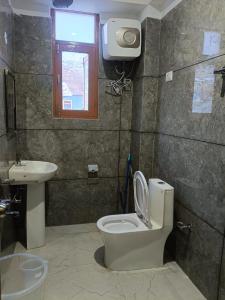 a bathroom with a toilet and a sink at Hotel Lake view in Nako