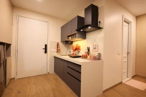 a kitchen with a white counter and a door at BlancHaus Stays - Premium Luxury I Viman Nagar I Near Pune Airport I Skyline View in Pune +16 photos