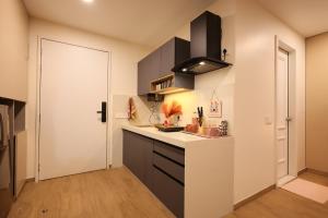 a kitchen with a white counter and a door at BlancHaus Stays - Premium Luxury I Viman Nagar I Near Pune Airport I Skyline View in Pune
