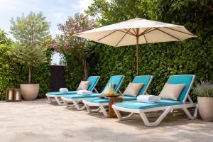 a group of chairs and an umbrella on a patio at Pula Paradise in Pula