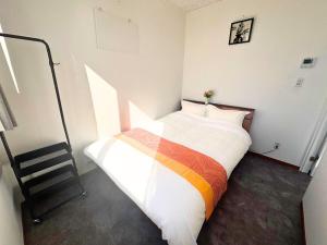 a bedroom with a bed and a staircase in it at Magokoro House 201 in Nishiizu