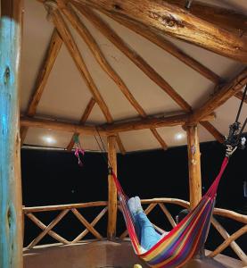 a person sleeping in a hammock in a room at Apu House in Calca