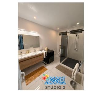 a bathroom with a tub and a sink and a shower at Kahaia stay lodge in Papeete +12 photos