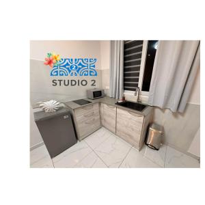 a bathroom with a sink and a desk in a room at Kahaia stay lodge in Papeete