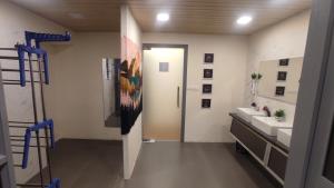a bathroom with two sinks and a door to a bathroom at Hostells - Backpacker Hostel near Pune Station in Pune +30 photos