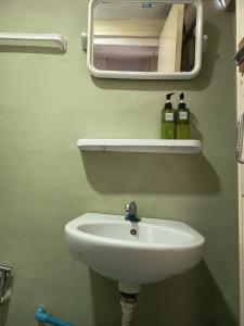 a bathroom with a white sink and a mirror at Row House Long Beach in Ko Lanta +55 photos