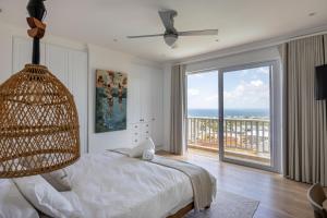 a bedroom with a bed and a large window at Plett Azure Guesthouse in Plettenberg Bay +79 photos