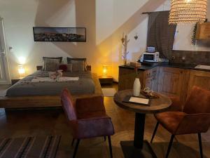 a bedroom with a bed and a table and chairs at Lofts avec Jacuzzi privatif - Spa Romantique - Bouzigues in Bouzigues +29 photos