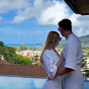 a man and a woman standing on top of a building at Villa Tantawan Resort - Private Pool Villas in Kamala Beach +171 photos