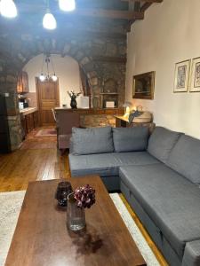 a living room with a couch and a table at Urban River House in Florina
