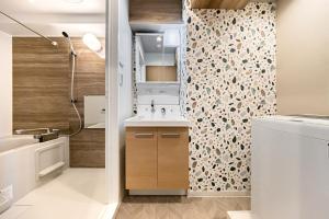 a small bathroom with a sink and a shower at Matcha Inn Sakura Tokyo in Tokyo +46 photos