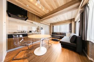 a kitchen and living room with a table and a couch at Matcha Inn Sakura Tokyo in Tokyo