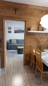 a living room with a couch and a table and chairs at Apartmán REZE Šumava in Železná Ruda