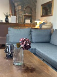 a vase with flowers on a table in a living room at Urban River House in Florina