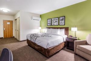 a hotel room with a bed and a couch at Sleep Inn Dallas Love Field-Medical District in Dallas +25 photos