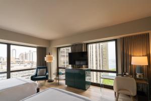 a hotel room with a bed and a large window at Thompson Chicago, by Hyatt in Chicago