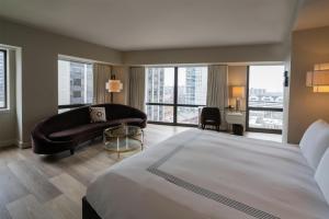 a bedroom with a bed and a couch and a desk at Thompson Chicago, by Hyatt in Chicago +46 photos